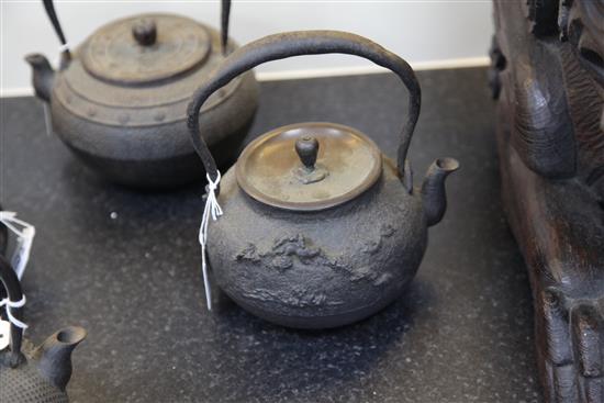 Five Japanese cast iron teapots, two with lacquer covers, 19th century, largest 19cm wide
